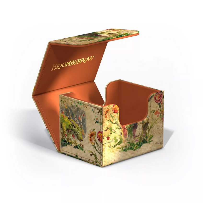 The Beza deck box opened up, showing how the box opens and revealing a golden Bloomburrow logo